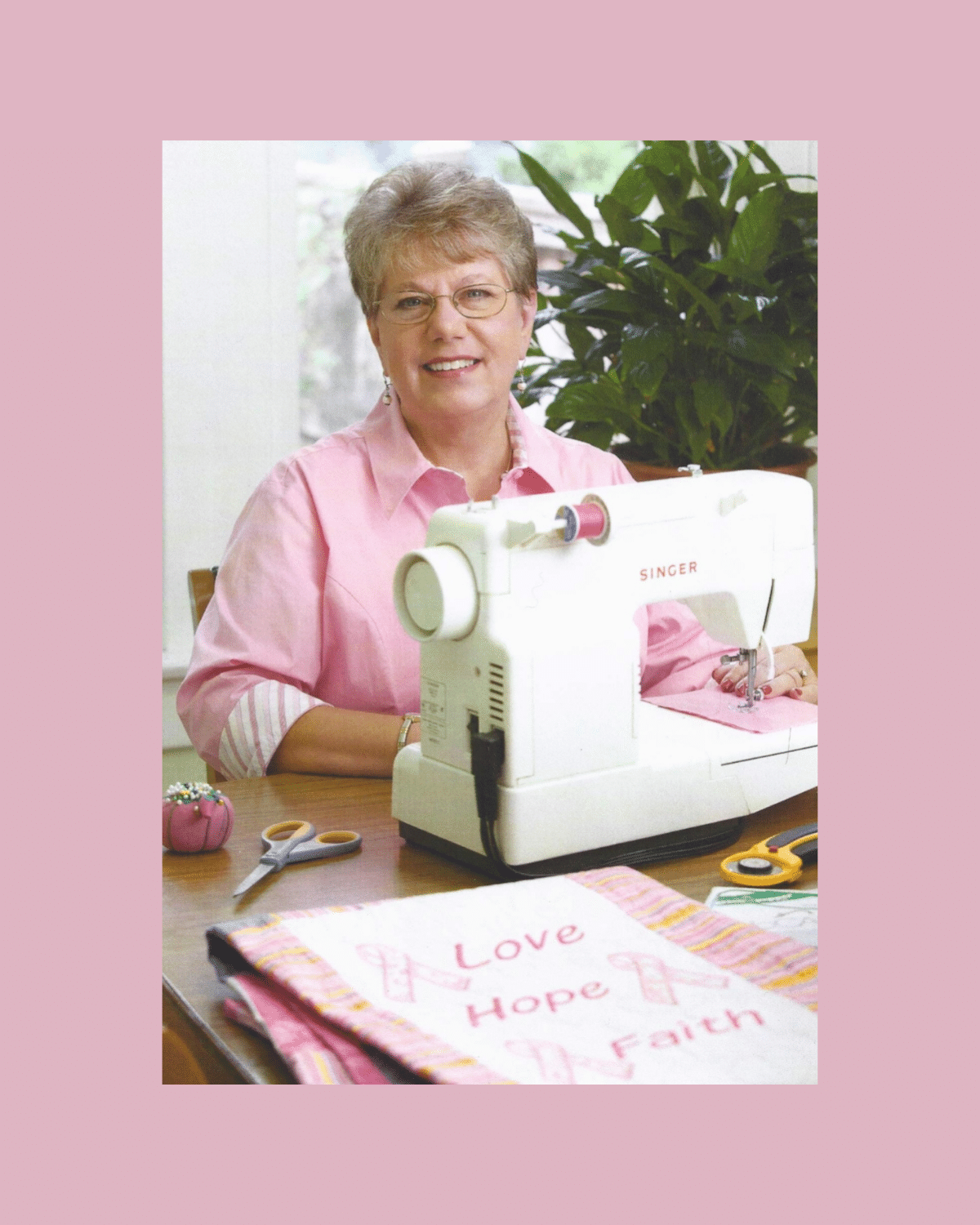 Carol sewing a quilt to be donated