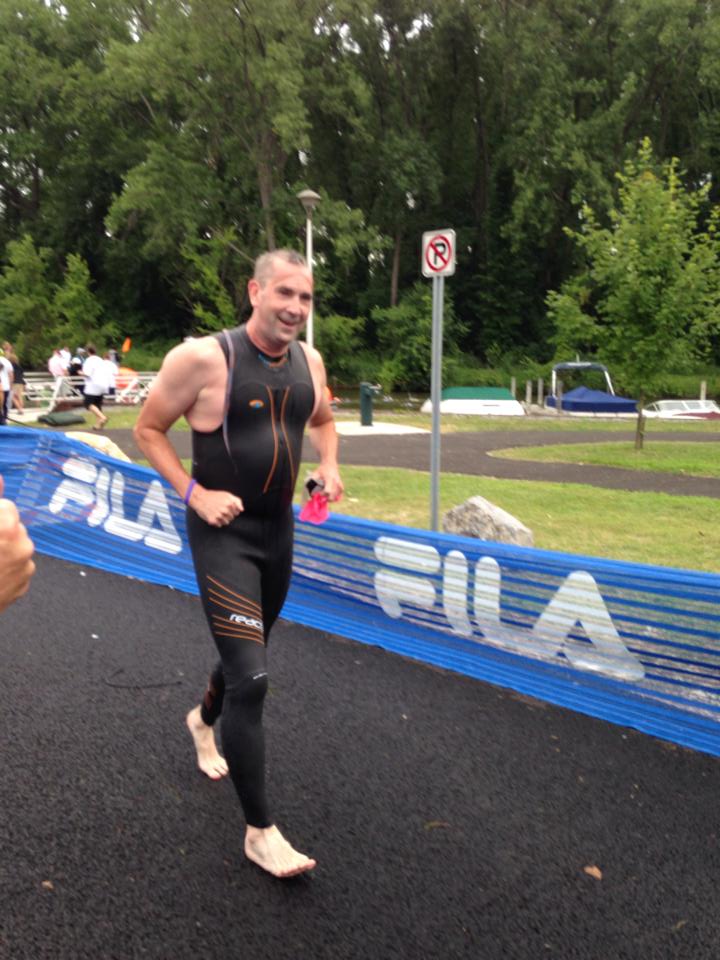 Greg running barefoot during a marathon