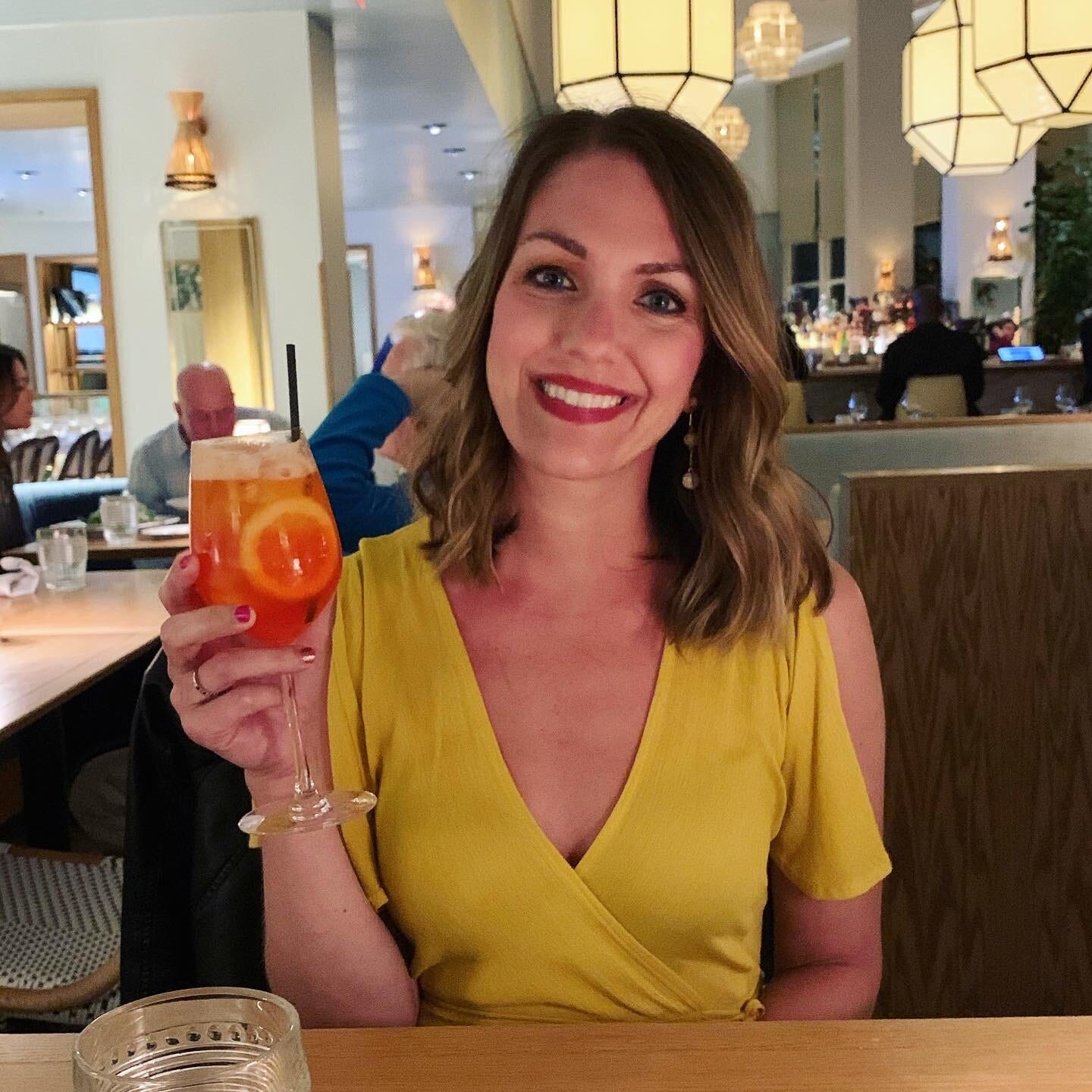 A cancer survivor holding up a refreshing drink to cheer.